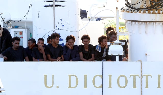 Migrants wait to disembark from the Italian coast guard vessel "Diciotti" at the port of Catania, Italy, August 22, 2018. REUTERS/Antonio Parrinello/File Photo