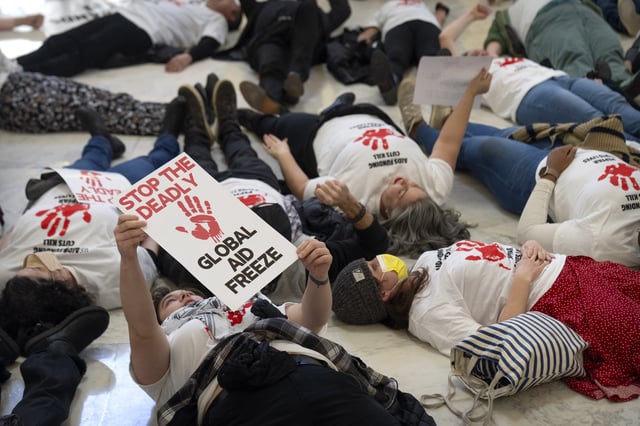 FILE - Demonstrators protest against cuts to American foreign aid spending, including USAID and the PEPFAR program to combat HIV/AIDS, at the Cannon House Office Building on Capitol Hill, Feb. 26, 2025, in Washington. (AP Photo/Mark Schiefelbein, file)