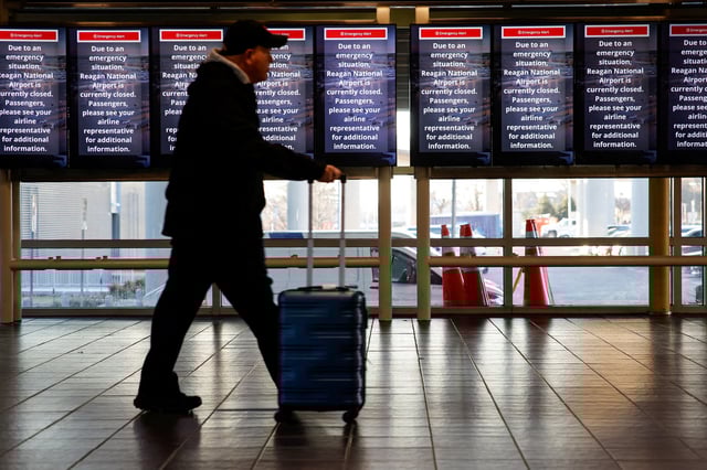 A person walks at Ronald Reagan Washington National Airport in Arlington, Virginia, U.S., January 30, 2025. REUTERS/Eduardo Munoz/File Photo