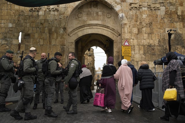 Israeli Border Police officers stand guard as Muslim worshippers make their way to the Al-Aqsa Mosque compound for the Friday prayers of the Muslim holy month of Ramadan in the Old City of Jerusalem, Friday, March 7, 2025. (AP Photo/Leo Correa)