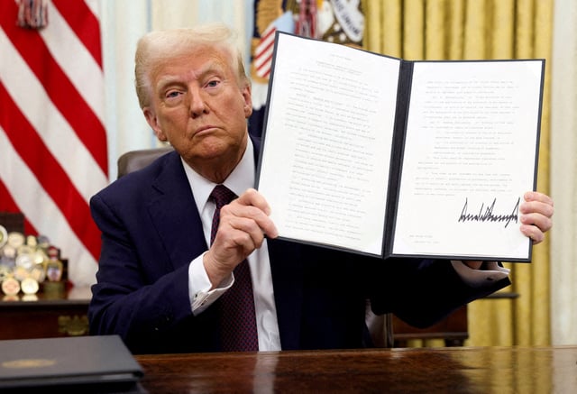 U.S. President Donald Trump holds a signed executive order on cryptocurrencies, in the Oval Office of the White House, in Washington, U.S., January 23, 2025.
