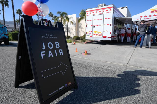 A sign sits in front of a job fair for employees who are not vaccinated against the coronavirus disease (COVID-19) in Temecula, California, U.S., December 4, 2021. REUTERS/Denis Poroy/File Photo
