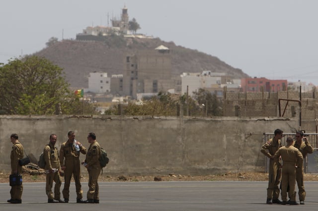 FILE - Members of a French military flight crew talk on the tarmac at France's military air base in Dakar, Senegal, Tuesday, June 2, 2009. (AP Photo/Rebecca Blackwell, File)