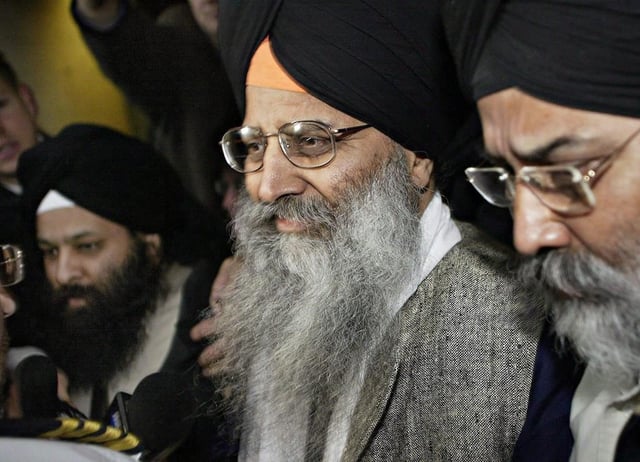 Ripudaman Singh Malik (centre) leaves B.C. Supreme Court in Vancouver, B.C., on March 16, 2005, surrounded by supporters after he was found not guilty in the 1985 bombing of Air India flight 182. Malik was killed in a 2022 shooting in Surrey, B.C.