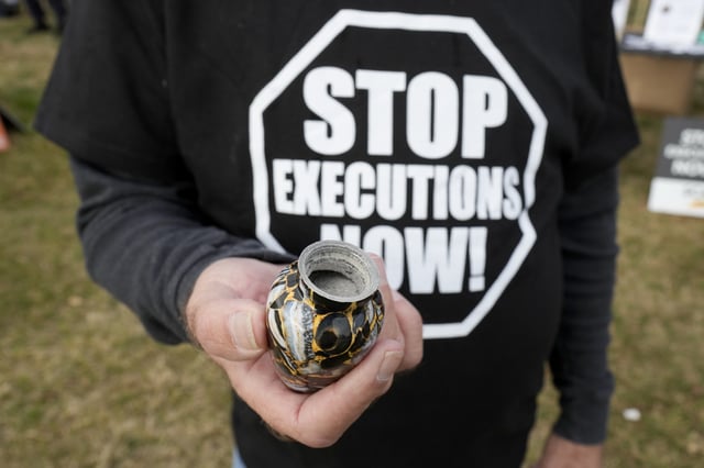 Randy Gardner, hold the ashes of his brother Ronnie the last death row inmate to be executed by firing squad during a protest outside the execution of South Carolina inmate Brad Sigmon, Friday, March 7, 2025, in Columbia, S.C. (AP Photo/Chris Carlson)