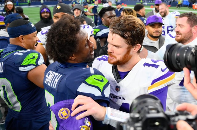 Geno Smith and Sam Darnold hug after the Vikings-Seahawks game in November.