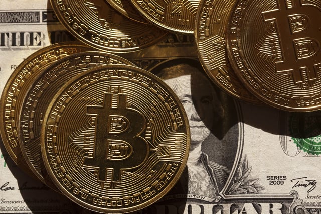 ILLUSTRATION - 06 March 2025, Berlin: Golden Bitcoin coins lie on a US dollar banknote. Photo by: Fernando Gutierrez-Juarez/picture-alliance/dpa/AP Images