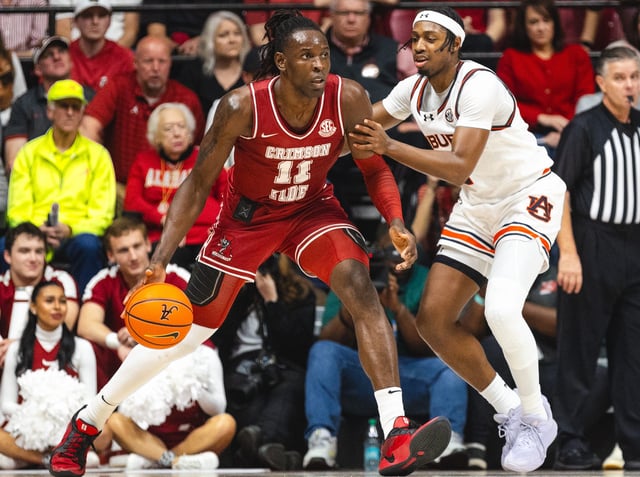 Alabama center Clifford Omoruyi (11) dribbles as Auburn guard Denver Jones (2) defends during their game at Coleman Coliseum.