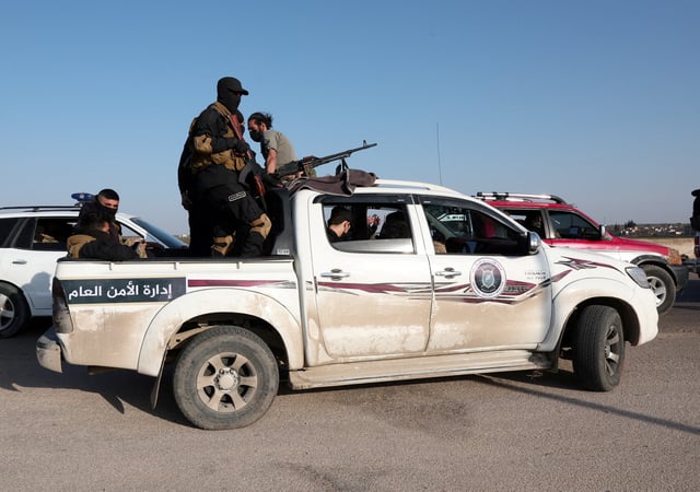 Syrian army personnel travel in a military vehicle as they head towards Latakia to join the fight against the fighters linked to Syria's ousted leader Bashar al-Assad, in Aleppo, Syria, March 7, 2025. REUTERS/Mahmoud Hassano/File Photo