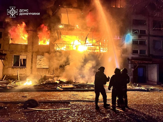 Firefighters work the site of a Russian strike on a residential area in Dobropillia, Donetsk region, Ukraine, on Saturday, March 8, 2025.