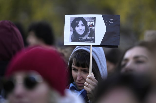 FILE - A woman holds up a photo of Giulia Cecchettin, the 22-year-old university student stabbed to death by her former boyfriend, on the occasion of International Day for the Elimination of Violence against Women, in Milan, Italy, Nov. 25, 2023. (AP Photo/Luca Bruno, File)