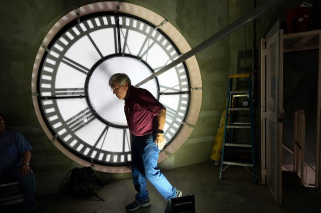 Don Bugh walks inside the historic mechanical clock tower atop the Dallas County Courthouse, in Dallas, on March 7, 2024. 