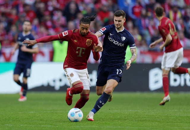 Soccer Football - Bundesliga - Bayern Munich v VfL Bochum - Allianz Arena, Munich, Germany - March 8, 2025 Bayern Munich's Michael Olise in action with VfL Bochum's Tom Krauss REUTERS/Leonhard Simon