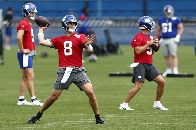 EAST RUTHERFORD, NEW JERSEY - JUNE 14: Quarterbacks Daniel Jones #8 and Tommy DeVito #5 of the New York Giants look to pass as Jacob Eason #5 looks on during the teams mini camp at Quest Training Center on June 14, 2023 in East Rutherford, New Jersey.