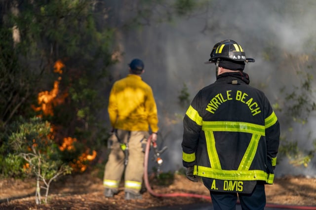 Firefighters attend to a flare-up on March 2, 2025, in Myrtle Beach, S.C.