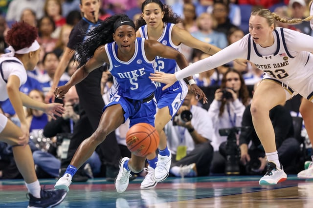 Mar 8, 2025; Greensboro, NC, USA; Duke Blue Devils guard Oluchi Okananwa (5) attacks the ball during the second quarter against Notre Dame Fighting Irish at First Horizon Coliseum. Cory Knowlton-Imagn Images