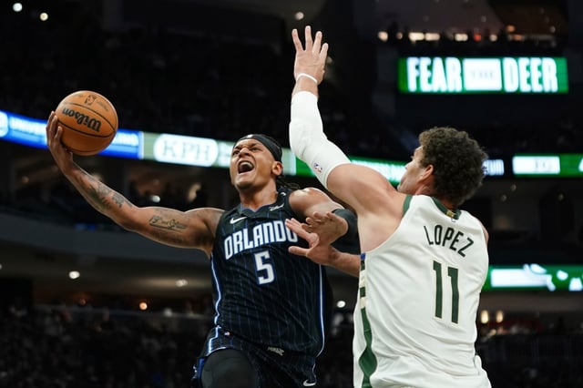 Orlando Magic&#39;s Paolo Banchero (5) shoots against Milwaukee Bucks&#39; Brook Lopez (11) during the first half of an NBA basketball game Saturday, March 8, 2025, in Milwaukee. (AP Photo/Aaron Gash)