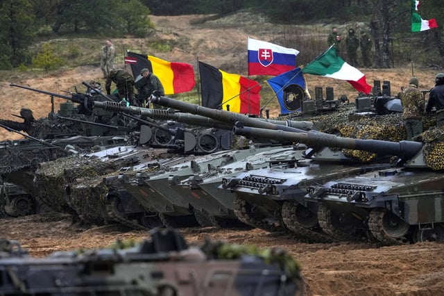 Tanks and military vehicles of NATO Enhanced Forward Presence battle groups stand together before live fire exercise, during Iron Spear 2022 military drill in Adazi, Latvia November 15, 2022.