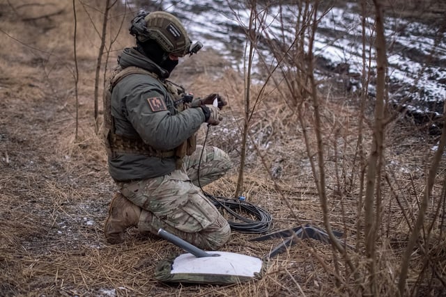 A Ukrainian serviceman of 47th brigade prepares a Starlink satellite internet systems at his positions at a front line, amid Russia's attack on Ukraine, near the town of Avdiivka, recently captured by Russian troops in Donetsk region, Ukraine February 20, 2024. REUTERS/Inna Varenytsia/File Photo