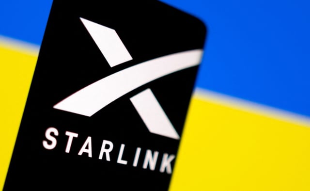 Starlink logo is seen on a smartphone in front of displayed Ukrainian flag in this illustration taken February 27, 2022. REUTERS/Dado Ruvic/Illustration/File Photo