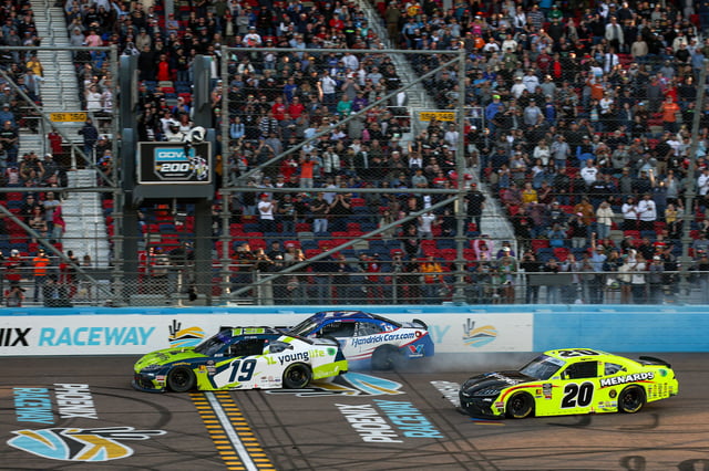 Aric Almirola, driver of the #19 Younglife Toyota, leads Alex Bowman, driver of the #17 HendrickCars.com Chevrolet, and Brandon Jones, driver of the #20 Menards/Pelonis Toyota, to the finish line to win the NASCAR Xfinity Series GOVX 200 at Phoenix Raceway on March 08, 2025 in Avondale, Arizona.