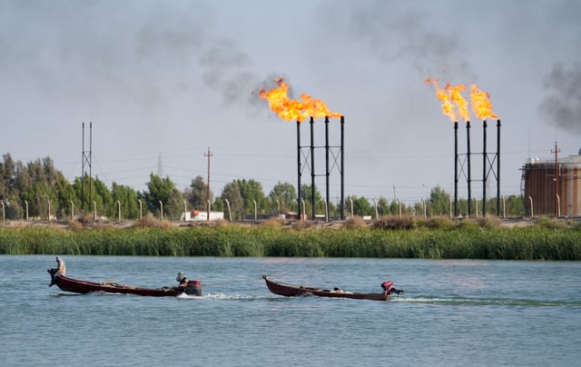 People navigate boats near Nahr Bin Umar oil field, in Basra, Iraq June 30, 2024. REUTERS/Mohammed Aty/File Photo