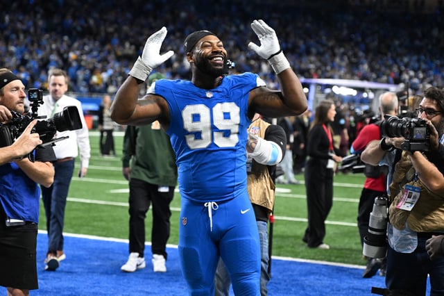 Dec 5, 2024; Detroit, Michigan, USA;  Detroit Lions defensive end Za'Darius Smith (99) celebrates with the fans as he walks off the field following the Lions win over the Green Bay Packers at Ford Field. Lon Horwedel-Imagn Images/File Photo