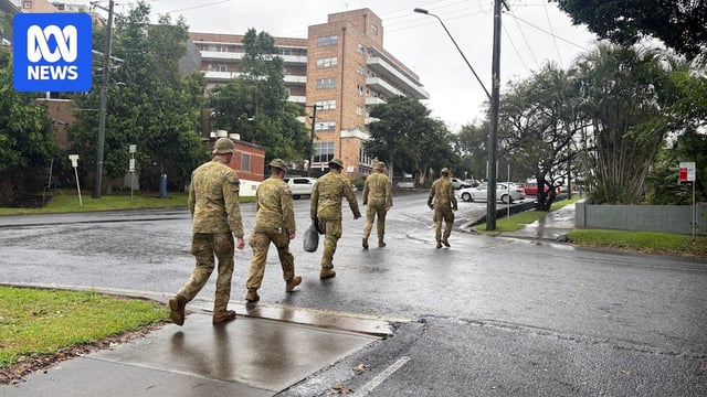 Defence force personnel walk outside Lismore Base Hospital