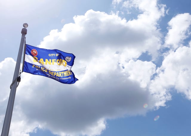 A police flag flies in front of the Sanford Police Department headquarters in Sanford, Florida, March 28, 2012.
