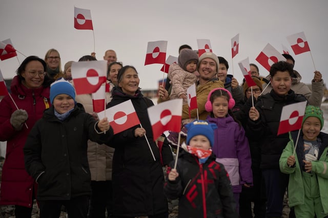 FILE - People wave Greenland flags during an event organized by Qupanuk Olsen, Greenland's most popular social media influencer and a candidate for the Naleraq party in the next March 11 election, in Nuuk, Greenland, Feb. 16, 2025. (AP Photo/Emilio Morenatti, file)