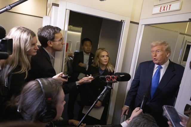 US President Donald Trump speaks to journalists aboard Aire Force One as he travels from West Palm Beach back to Washington on March 9, 2025.