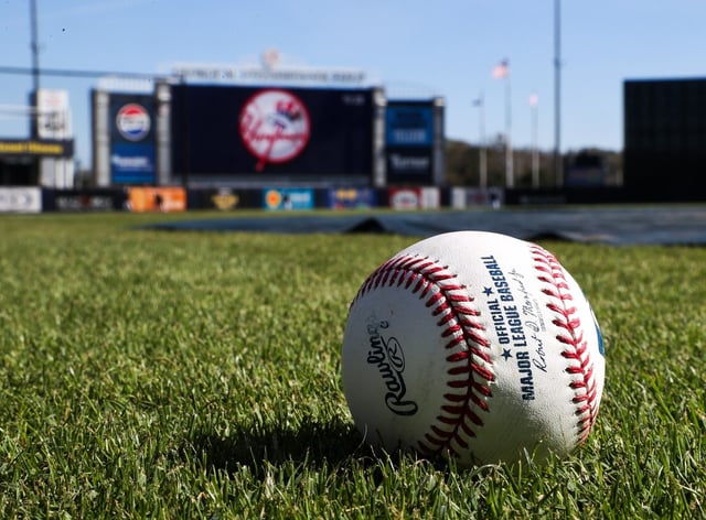 A baseball rests in the grass near home plate at Tampa&#39;s Steinbrenner Field, where the Rays will play their regular-season home games this year. The team is displaced pending repairs to Tropicana Field, which sustained damage during Hurricane Milton. (Dirk Shadd/Tampa Bay Times)