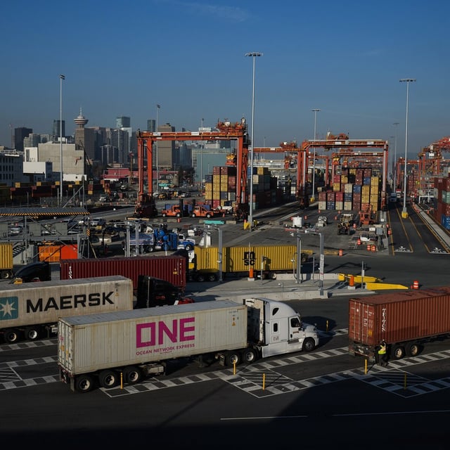 Trucks carrying cargo containers arrive at the Port of Vancouver Centerm container terminal, in Vancouver, on Friday, October 14, 2022. THE CANADIAN PRESS/Darryl Dyck