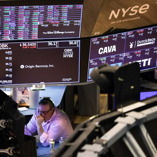 A trader works on the floor of the New York Stock Exchange (NYSE) at the opening bell in New York City on March 10, 2025.