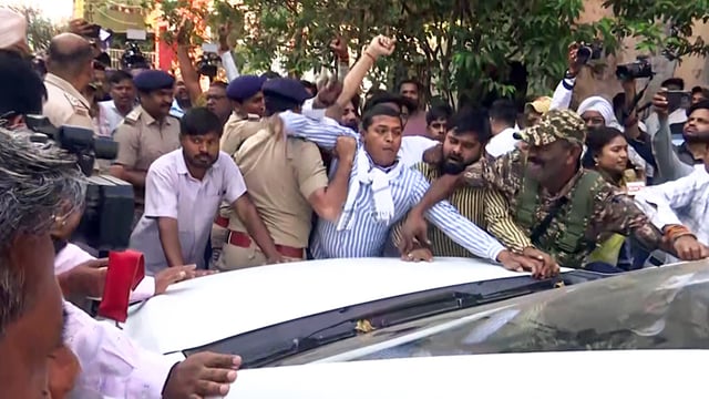 Enforcement Directorate (ED) personnel being stopped as they leave after searching the residence of former Chief Minister and Congress leader Bhupesh Baghel in an ongoing money laundering case, in Durg on Monday.