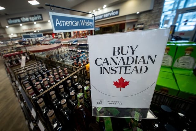 A sign is placed in front of the American whiskey section at a B.C. liquor store after top selling American made products have been removed from shelves in Vancouver, Sunday, Feb. 2, 2025. 