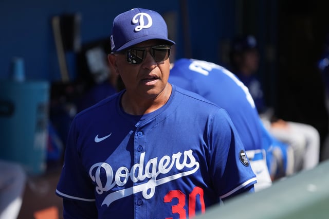 Mar 8, 2025; Phoenix, Arizona, USA; Los Angeles Dodgers manager Dave Roberts (30) gets ready against the Chicago White Sox before a game at Camelback Ranch-Glendale. Mandatory Credit: Rick Scuteri-Imagn Images/File Photo