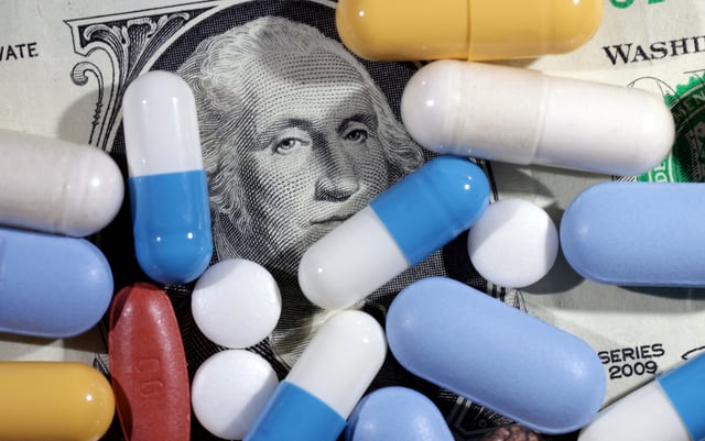 U.S. dollar banknote and medicines are seen in this illustration taken, June 27, 2024.