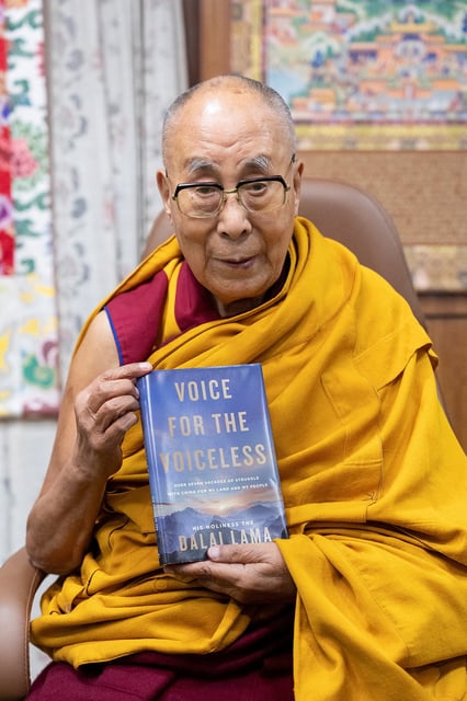 The Dalai Lama poses with his new book "Voice for the Voiceless" in this photograph posted on his X account on January 24, 2025 in India. The Dalai Lama via X/Handout via REUTERS/ File Photo