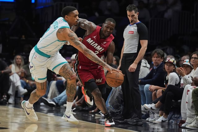 Charlotte Hornets guard DaQuan Jeffries (3) and Miami Heat guard Terry Rozier (2) go after the ball during the first half of an NBA basketball game, Monday, March 10, 2025, in Miami. (AP Photo/Marta Lavandier)