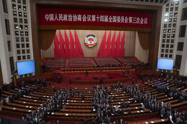 Delegates file out after the closing ceremony of the Chinese People's Political Consultative Conference held at the Great Hall of the People in Beijing, Monday, March 10, 2025. (AP Photo/Ng Han Guan)