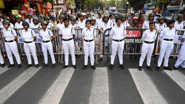 Police personnel stand guard amid a protest rally against TMC and the Left at Jadavpur University campus in Kolkata. (Samir Jana/ HT Photo)
