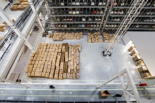 People walk near boxes, at Mango's logistics center, in Llica d'Amunt, near Barcelona, Spain, March 10, 2025. REUTERS/Albert Gea