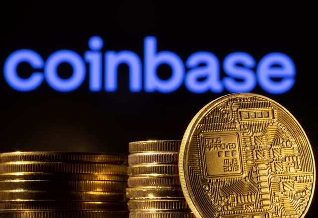 A representation of the cryptocurrency is seen in front of Coinbase logo in this illustration taken, March 4, 2022. REUTERS/Dado Ruvic/Illustration/File Photo