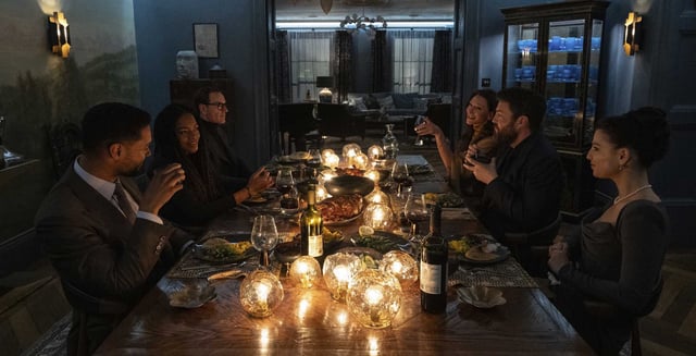 British agents gather for dinner in Steven Soderberg’s “Black Bag.: Regé-Jean Page, left, Naomie Harris, Michael Fassbender, Cate Blanchett, Tom Burke and Marisa Abela.