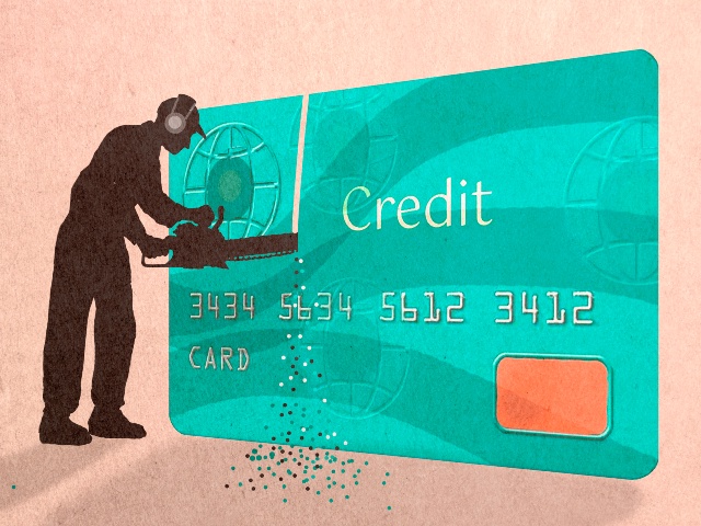 Silhouette man cutting credit card with chainsaw