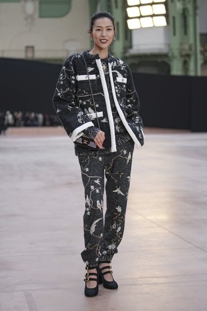 Liu Wen arrives for the the Chanel Fall/Winter 2025-2026 Womenswear collection presented Tuesday, March 11, 2025. in Paris. (AP Photo/Christophe Ena).