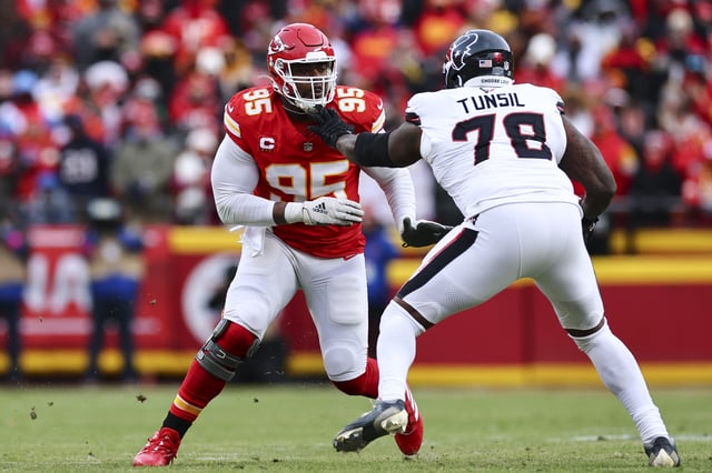 Chris Jones #95 of the Kansas City Chiefs pressures the pocket as Laremy Tunsil #78 of the Houston Texans blocks during the first half of the AFC Divisional playoff game at GEHA Field at Arrowhead Stadium.