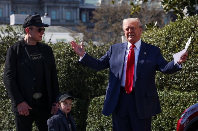 U.S. President Donald Trump talks to the media, next to Tesla CEO Elon Musk and his son X Æ A-12, with a Tesla car in the background, at the White House in Washington, D.C., U.S.,