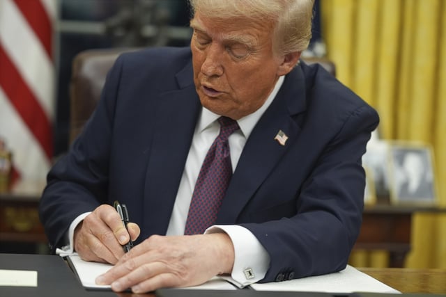 FILE - President Donald Trump signs an executive order on birthright citizenship in the Oval Office of the White House in Washington, Jan. 20, 2025. (AP Photo/Evan Vucci, File)